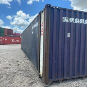 A professional delivery of a 20ft one-trip shipping container being placed on a level gravel foundation.